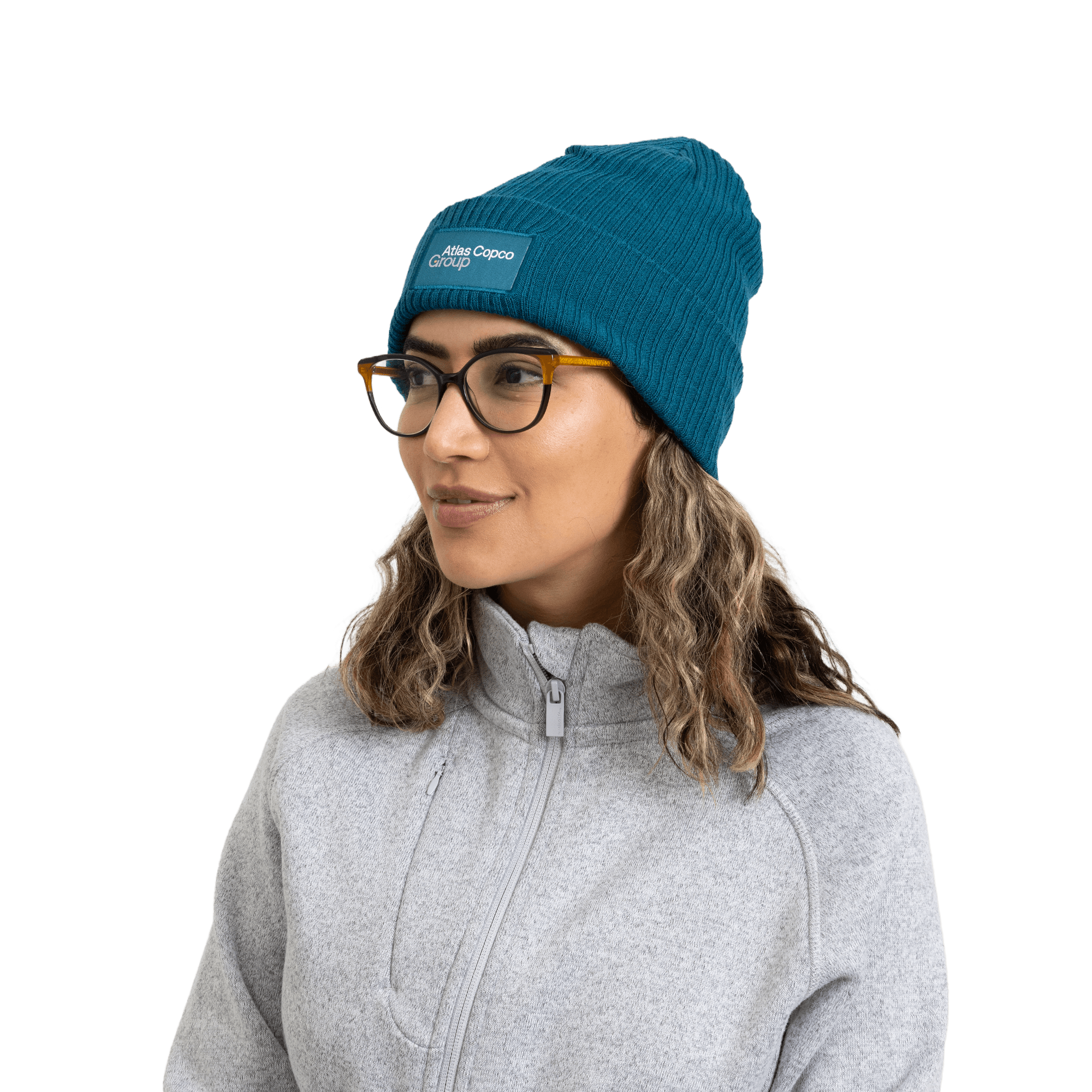 woman wearing teal winter hat with atlas copco group logo