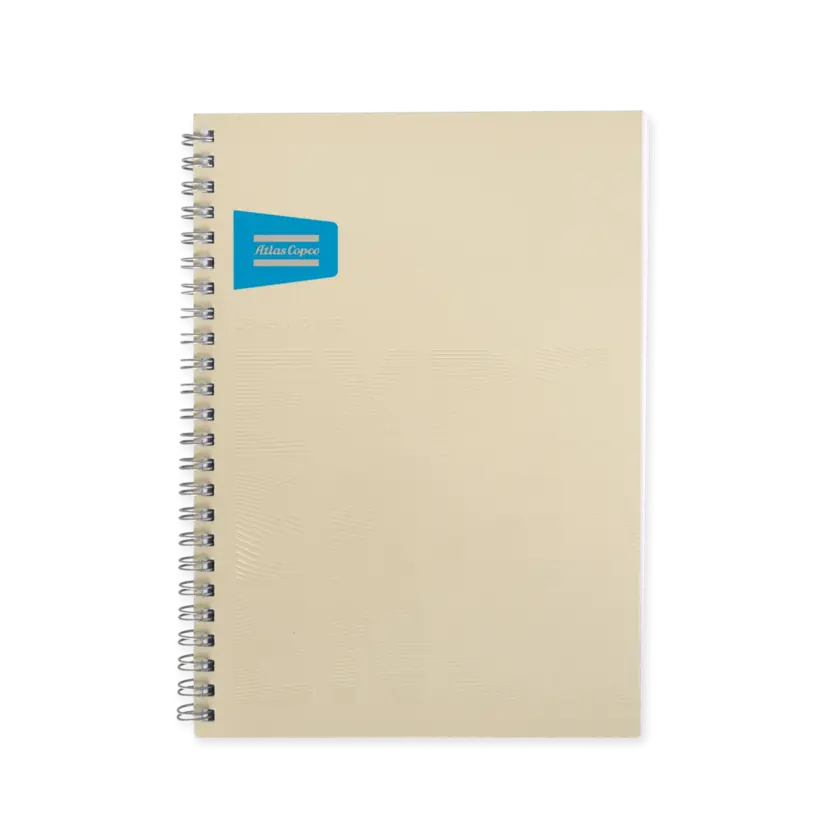 two beige notebooks with atlas copco logo and brand promise in beige embossed text