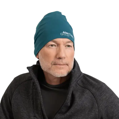 man wearing teal beanie with atlas copco group logo