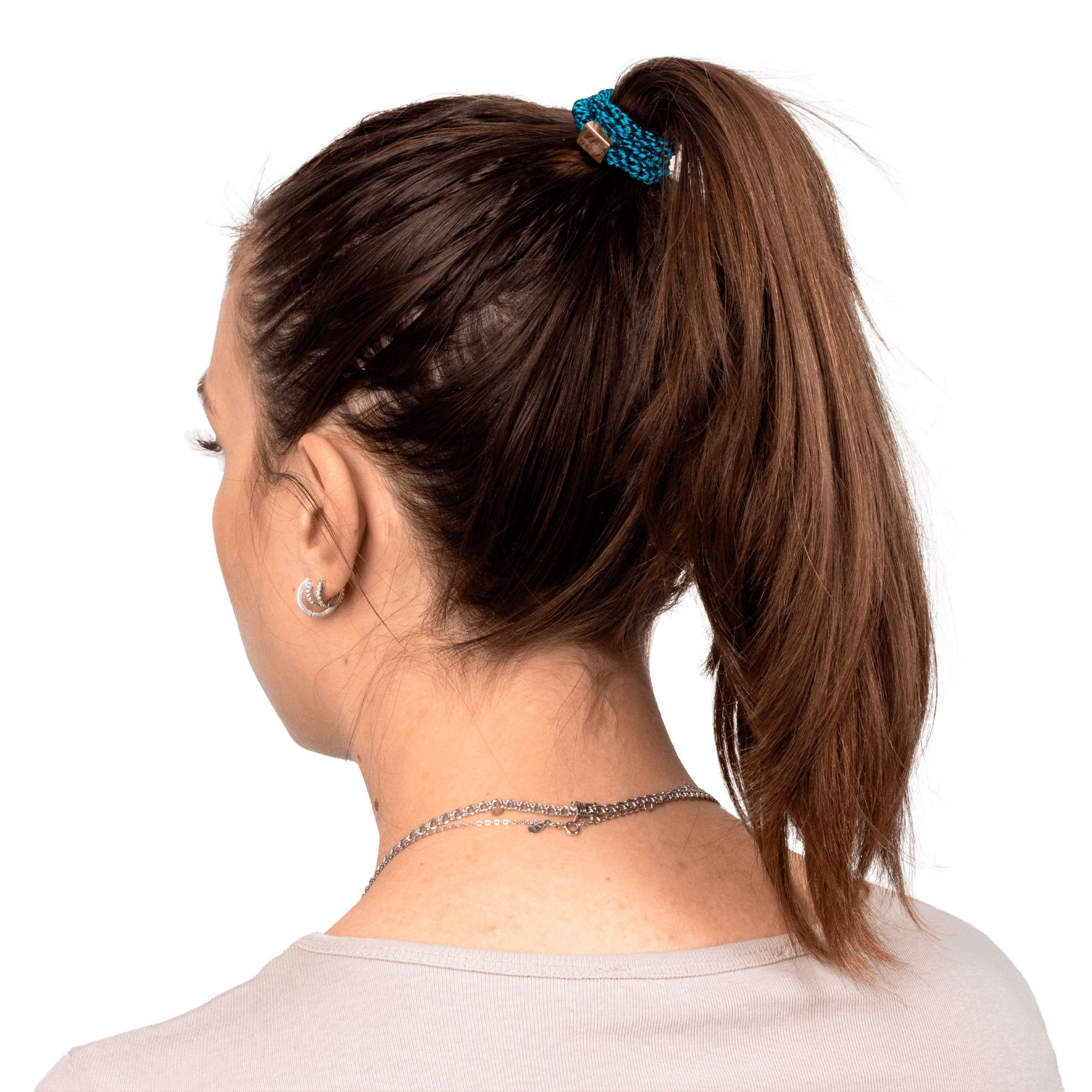 teal hair tie with golded box and atlas copco group logo in hair