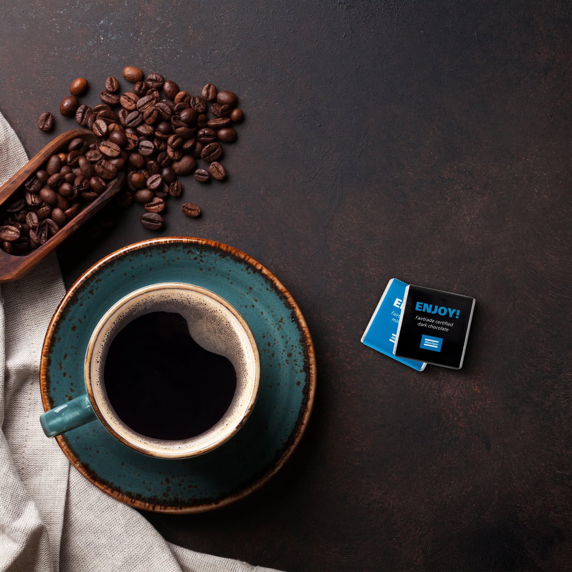 Chocolate with atlas copco logo and enjoy text