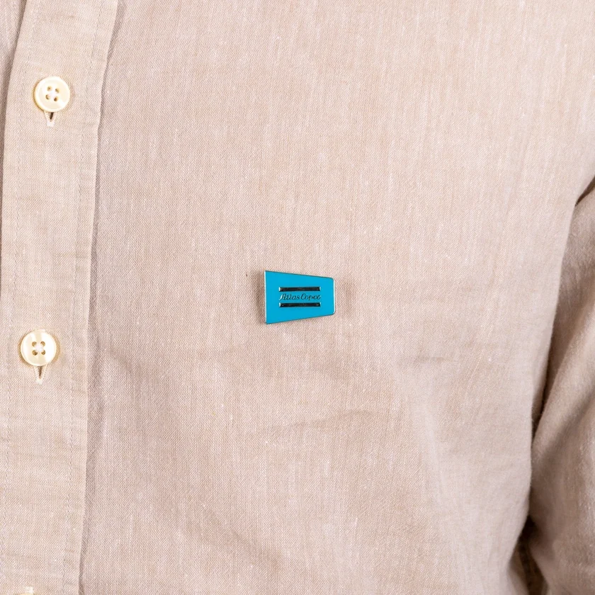 metal pin with atlas copco logo on shirt